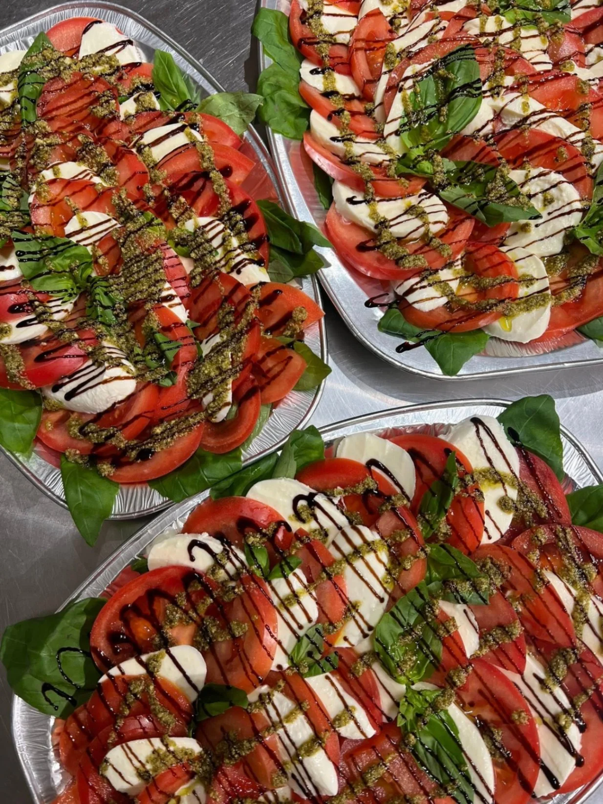 Caprese platters with mozzarella, tomato and pesto